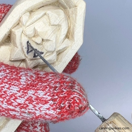 Carving mouth on wood carved vampire