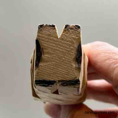 Shoe is sketched on wood carved Viking