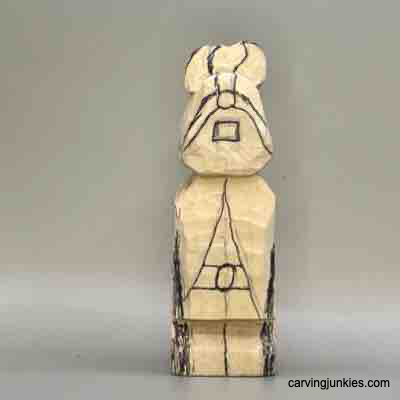 Front details are sketched on wood carved Viking