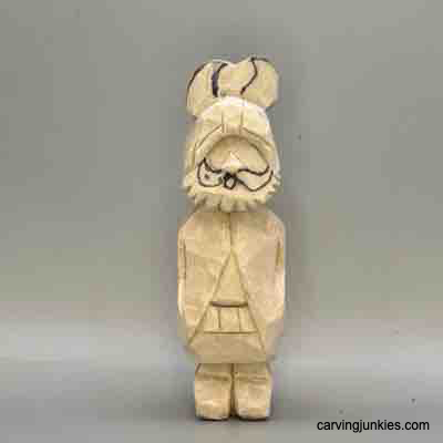 Mustache is sketched on wood carved Viking