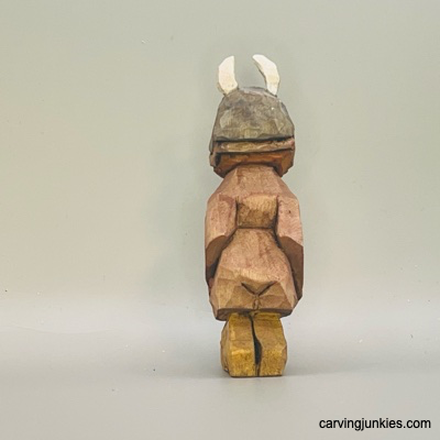 Back view of painted wood carved Viking