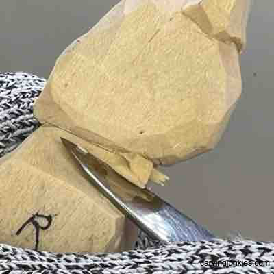 Shaping shoulder on wood carved Viking