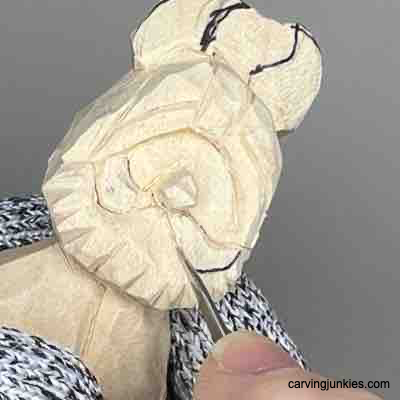 Carving the mustache on wood carved Viking