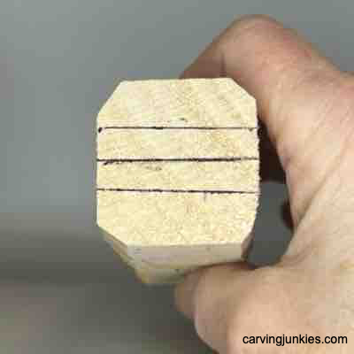 Guidelines sketched on top of block for wood carved Viking