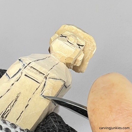 Carving hands on wood carved wizard Separating hands on wood carved wizard