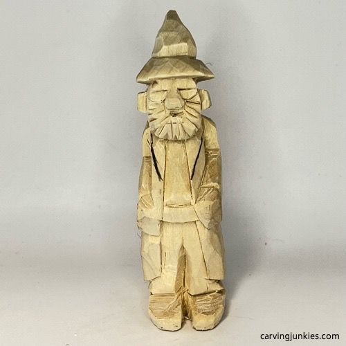 Drawn lapels of robe on wood carved wizard Adding lapels to wood carved wizard