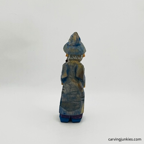 Painted back view of wood carved wizard Painted back side of wood carved wizard