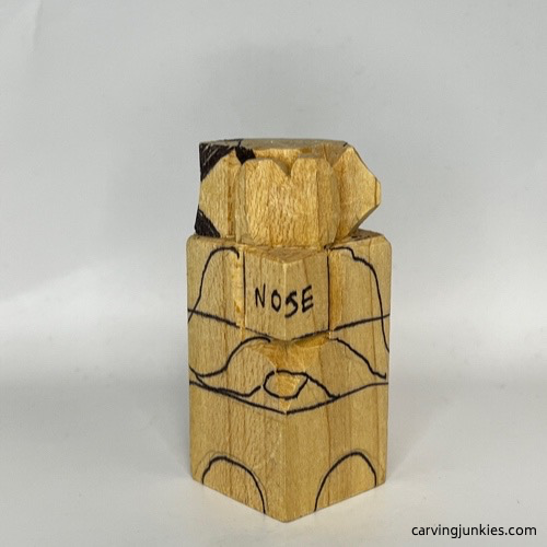 Progress on right ear of wooden dog carving