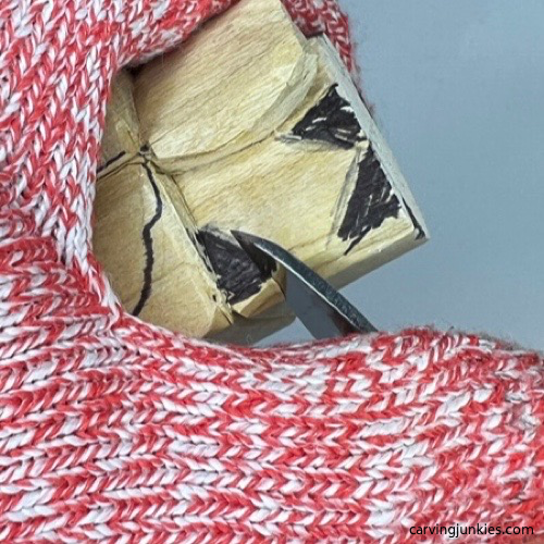 Shaping ear on wooden carved dog