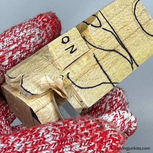 Removing wood in layers on wooden carved dog