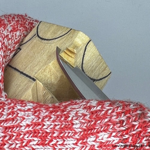 Removing wood in layers on wood dog carving