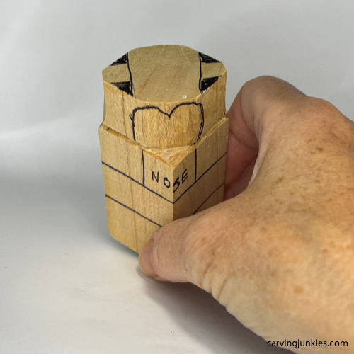 Eye sockets drawn on wood carved dog