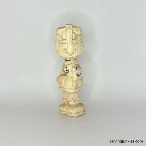 Helmet completed on carved wooden knight