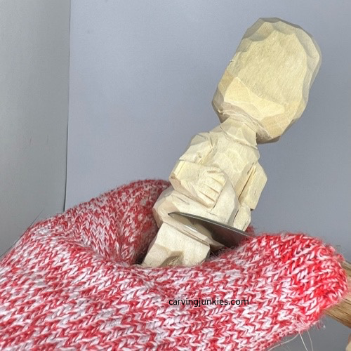 Cutting cloak on carved wooden knight