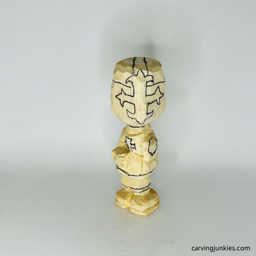 Drawn helmet on carved wooden knight