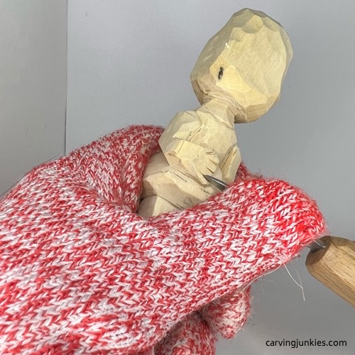 Carving fingers on carved wooden knight