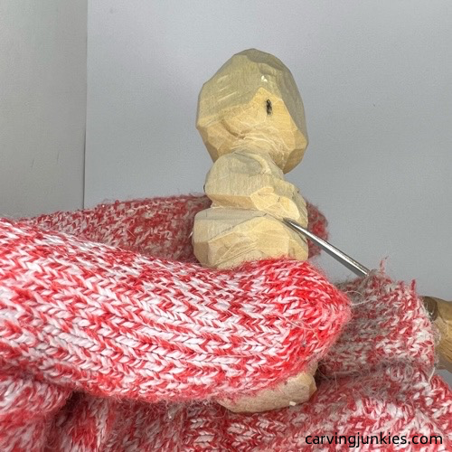 Rounding hands on carved wooden knight