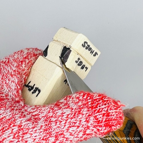 Cutting legs to carve a wooden knight