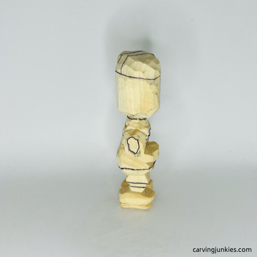 Drawn details on right side of carved wooden knight