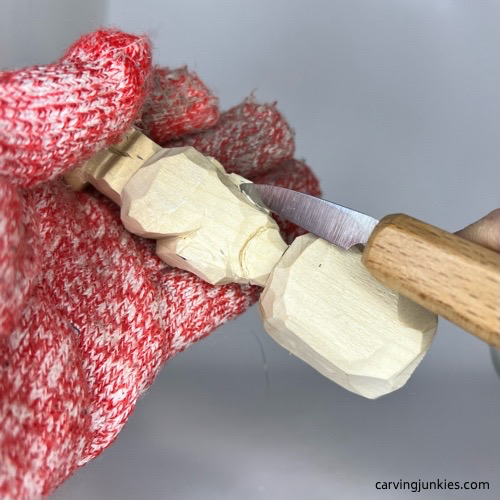 Refining shoulders on carved wooden knight
