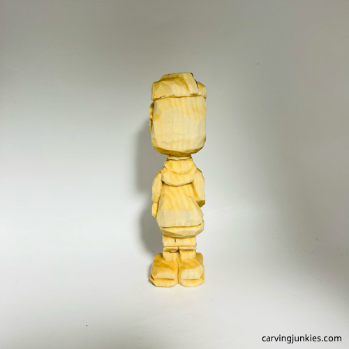 Back side of carved wooden knight before painting