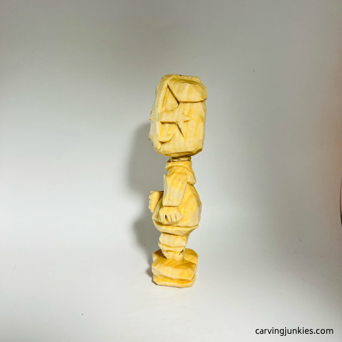 Left view of carved wooden knight before painting