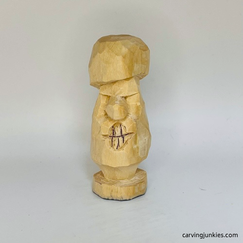 Teeth drawn on wooden mushroom carving
