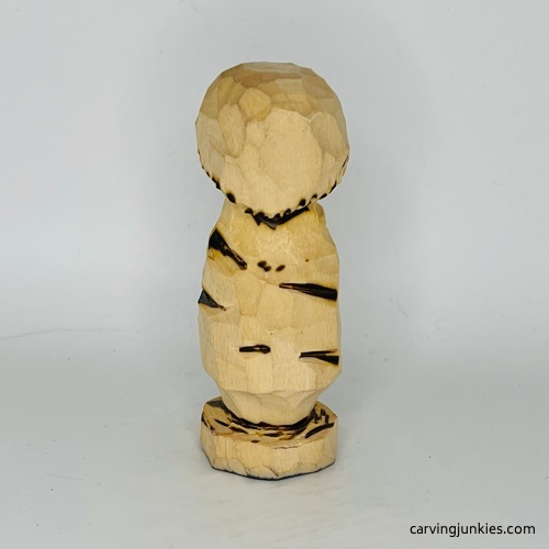 Wood burned details on back of wooden mushroom carving