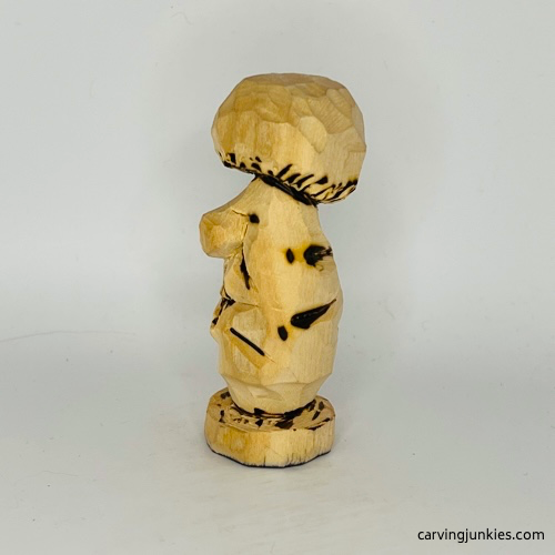 Wood burned details on left of wooden mushroom carving