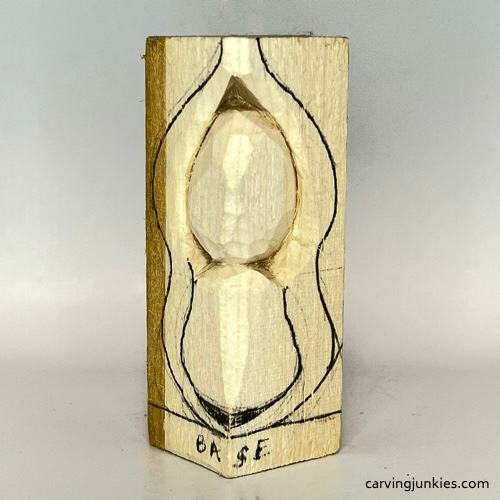 Carving faces on pea pod wood carving Separating face on pea pod wood carving