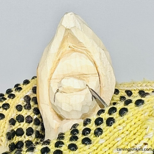 Carving smile lines on pea pod wood carving Adding smile lines on pea pod wood carving