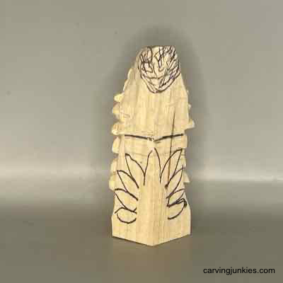 Make your own quirky turkey decorations from a block of wood—find out how! Feathers sketched on back of wooden turkey