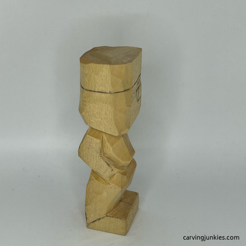 Chest is shaped on little man caricature carving