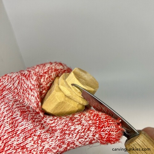 Carving hat on little man caricature carving