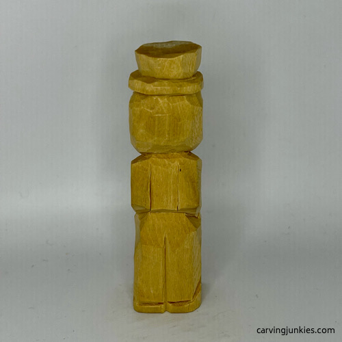 Back legs and arms carved on little man caricature carving