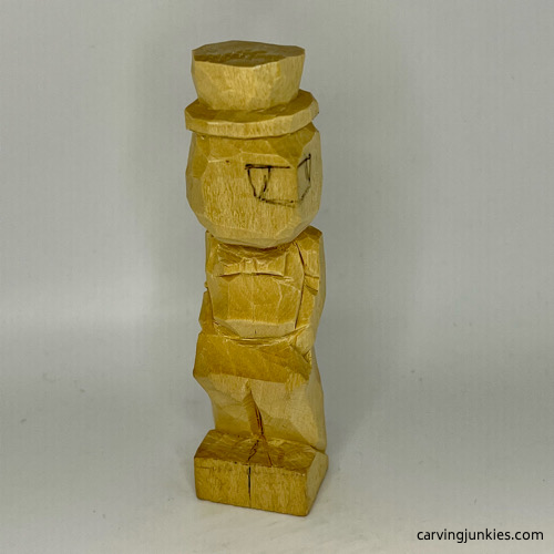 Split legs on little man caricature carving