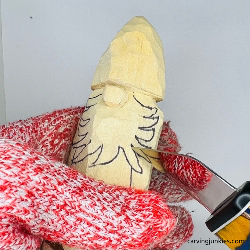 Cutting beard on wooden gnome