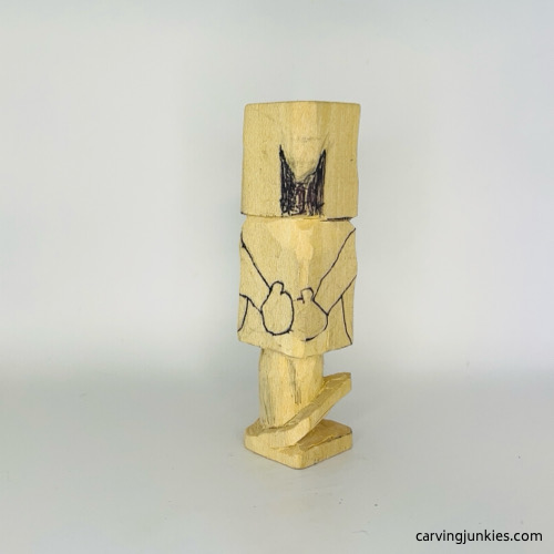 Back view of hands on wooden gnome