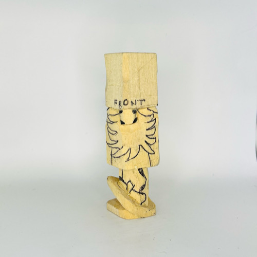 Drawing beard on wood gnome