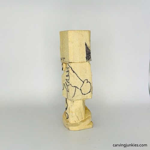 Left view of hands clasped on wooden gnome