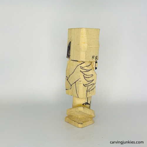 Hands clasped behind wooden gnome