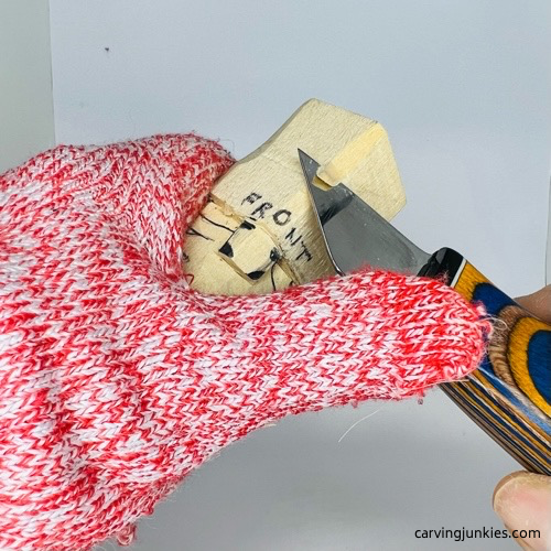 Carving hat on wooden gnome