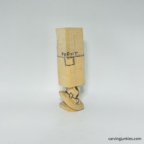 Carving legs on wooden gnome