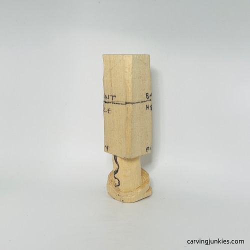 Left view of carved legs on wooden gnome