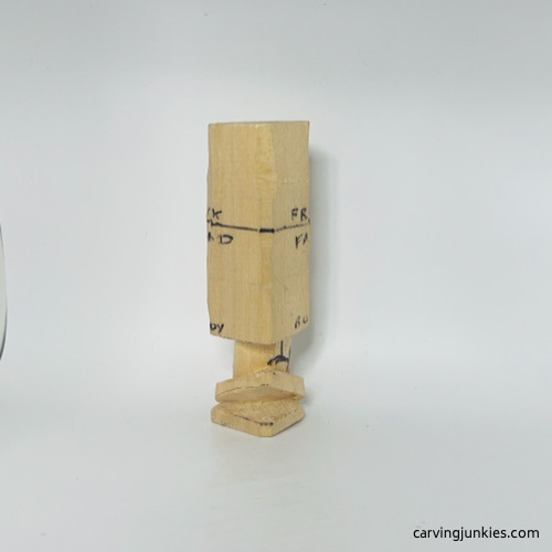 Right view of carved legs on wooden gnome