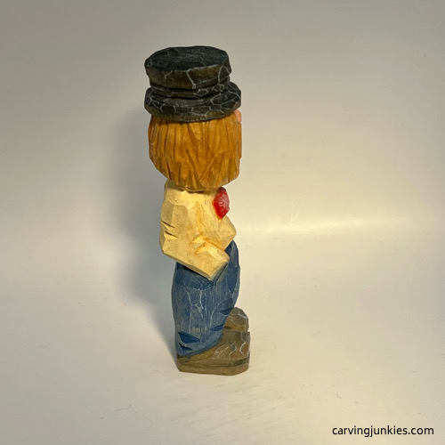 Right view of painted little man caricature carving
