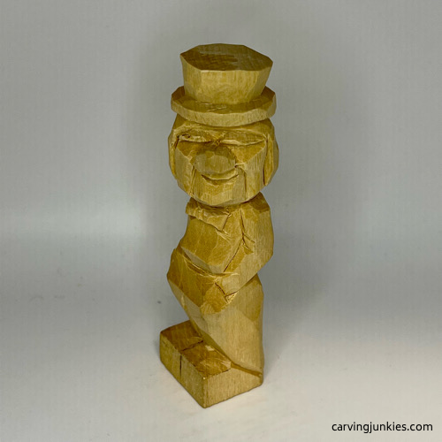 Carved details on front of little man caricature carving