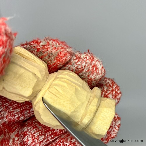 Carving hair on little man caricature carving