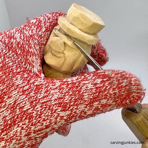 Carving eyebrow on little man caricature carving