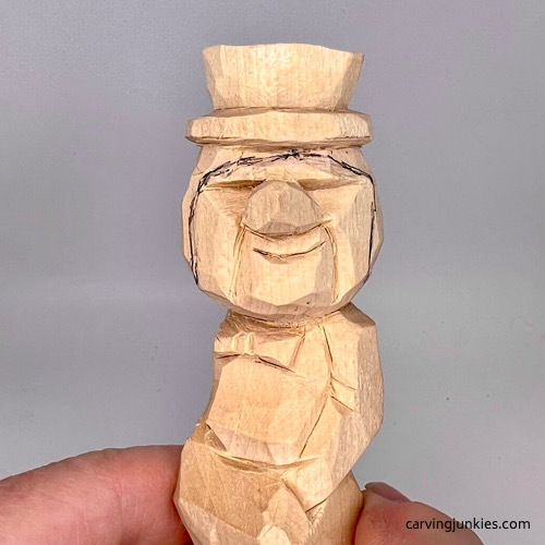Adding hairline to little man caricature carving
